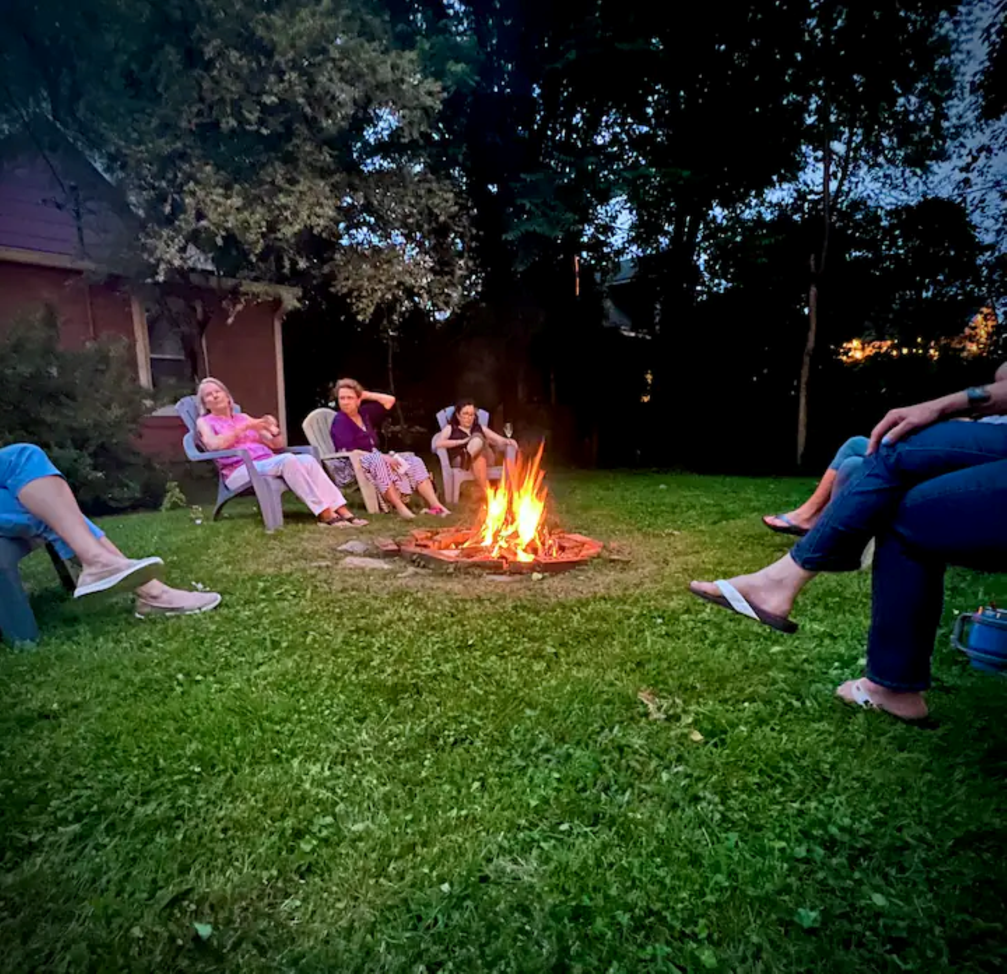 Guests gathered around a fire at the property